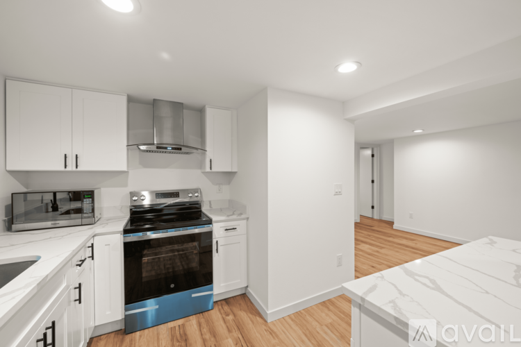 A kitchen with white cabinets and a blue oven.