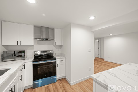 A kitchen with white cabinets and a blue oven.