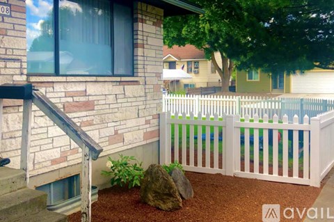 A house numbered 08 with a white picket fence.