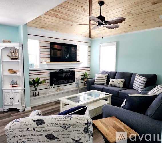 A living room with a fireplace and a television.