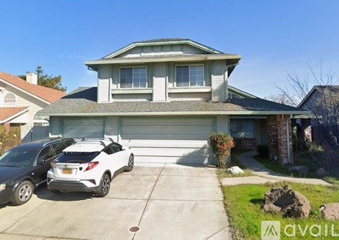A house with a car parked in front of it.