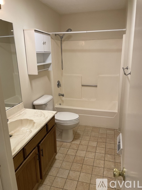 A bathroom with a toilet, sink, and bathtub.