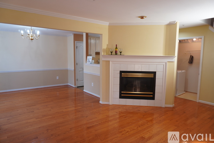 A living room with a fireplace and a chandelier.