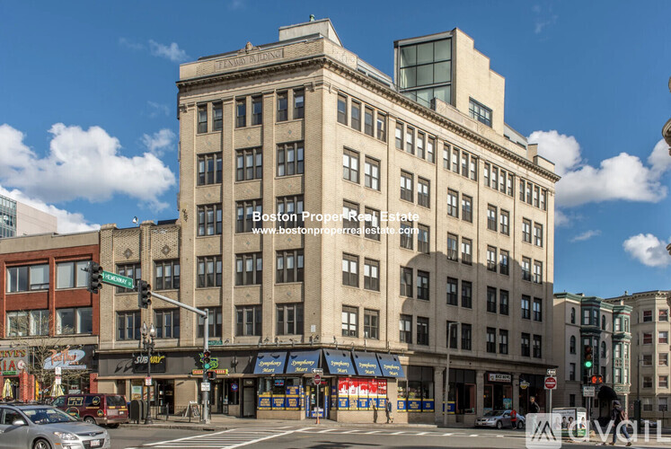 A street view of a building with the sign "Boston Property Group" on it.
