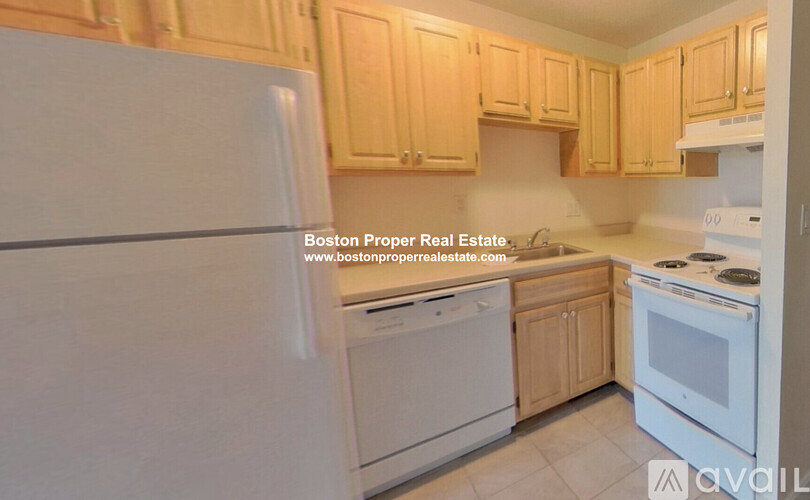 A kitchen with wooden cabinets and white appliances is on the market.