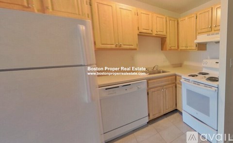 A kitchen with wooden cabinets and white appliances is on the market.