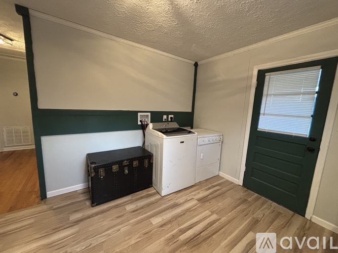 A room with a washer and dryer in it.