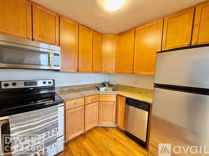 A kitchen with wooden cabinets and stainless steel appliances.