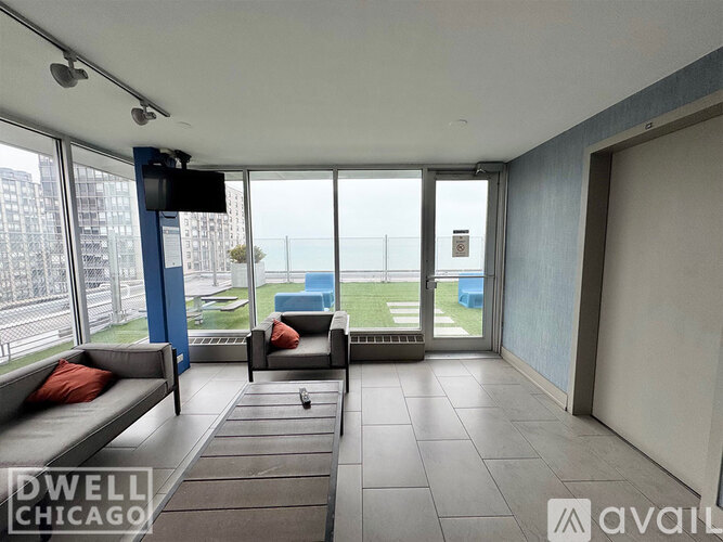 A living room with a couch and a television with a Dwell Chicago logo.