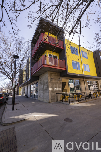 A multi-story building with a yellow and red facade is shown.