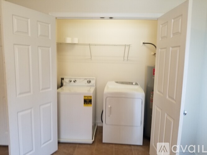 A small laundry room with a washer and dryer.