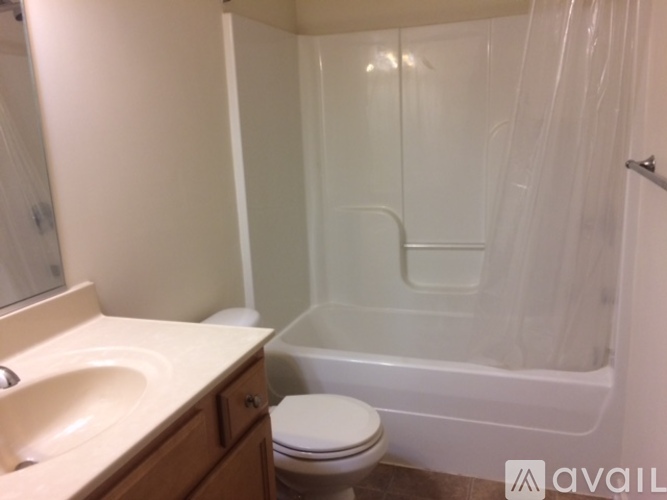 A bathroom with a toilet, sink, and bathtub.