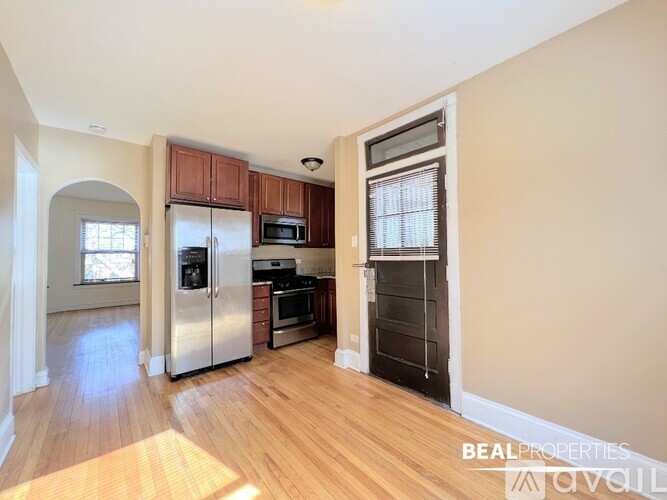 A kitchen with wooden cabinets and a refrigerator.