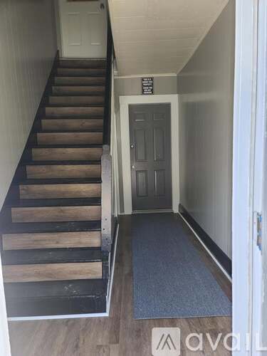 A set of stairs with a mat on the floor.