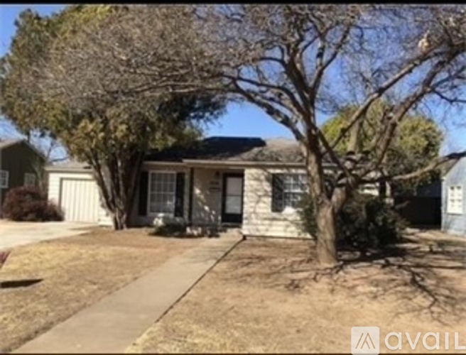 A house with a tree in front of it.
