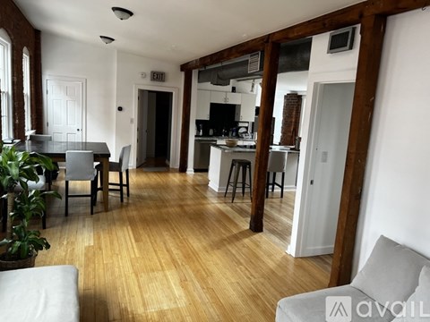 A living room with a dining table and chairs.