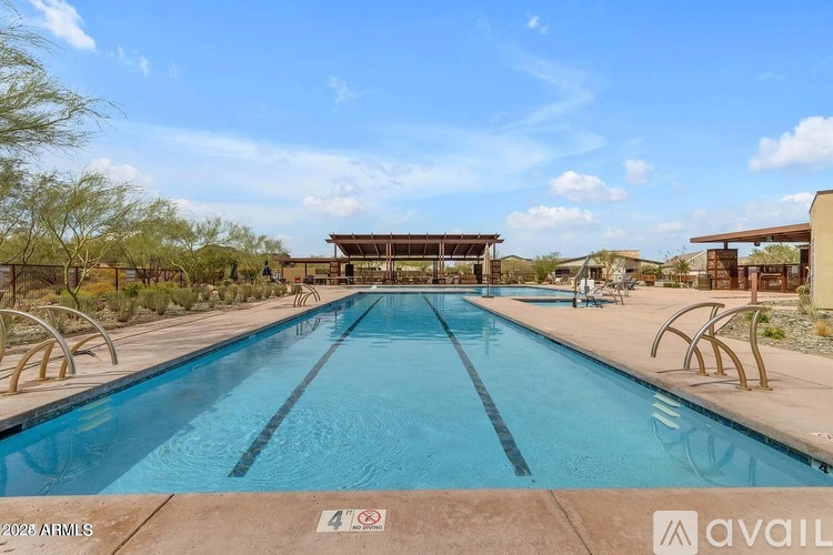 A large outdoor swimming pool with a building in the background.