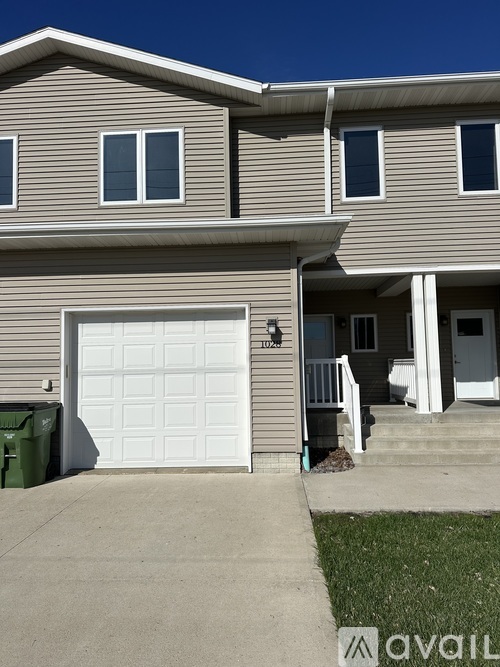 A two-story house with a white garage door.