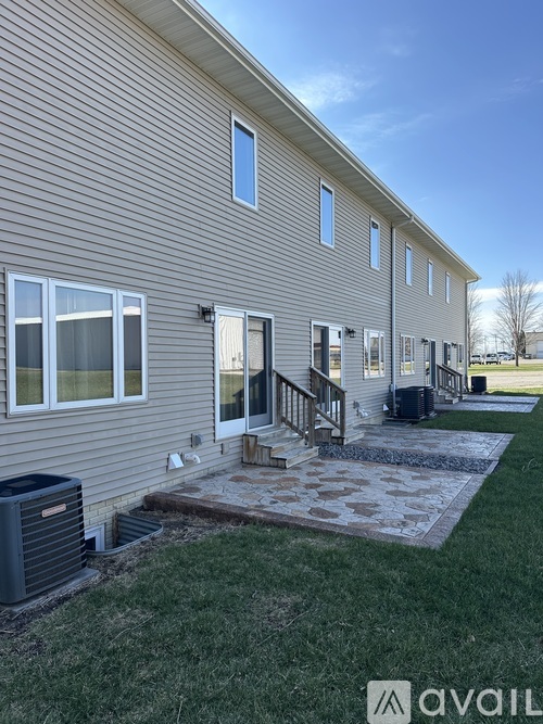 A house with a grey siding and a white door is shown.