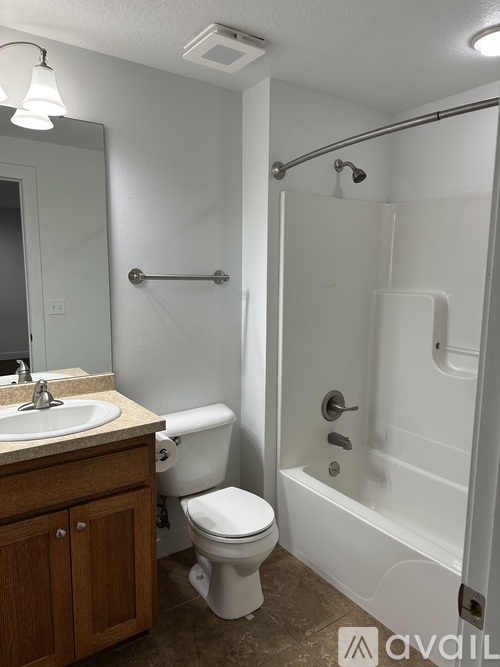 A bathroom with a toilet, sink, and bathtub.