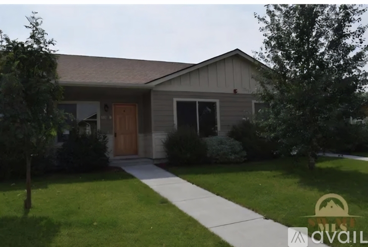 A house with a brown door and a white fence.