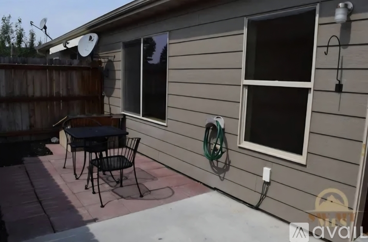 A patio with a table and chairs is shown.