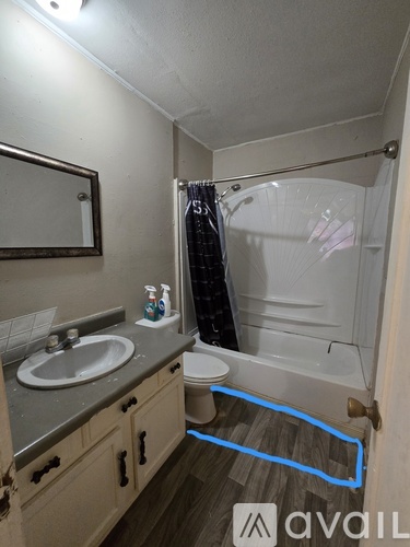 A bathroom with a sink, toilet, and bathtub.