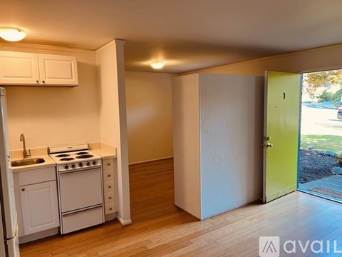 A kitchen with white appliances and cabinets is shown.