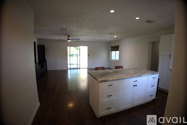 A large, empty room with a bed and a TV.