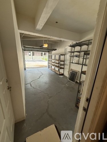 A room with a concrete floor and a doorway leading to a garage.