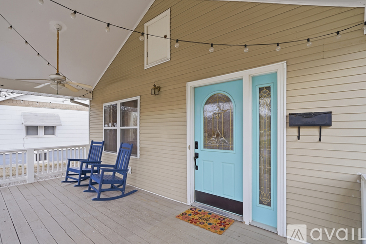 A blue door is on the right side of a house.