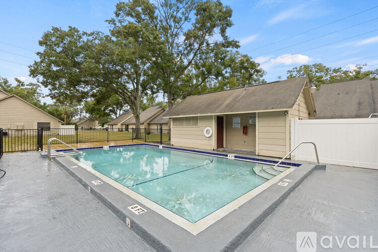 A pool in a backyard with a house in the background.
