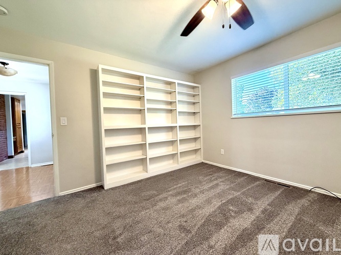 A bedroom with a built-in bed and storage space.