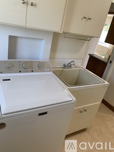 A white dishwasher and sink in a kitchen.