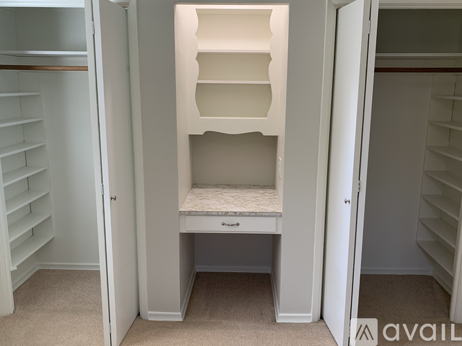 A small white closet with a built-in bench seat.