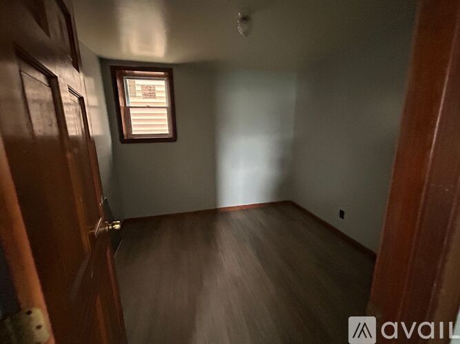A room with wooden floors and a window.