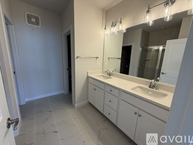 A bathroom with a sink, mirror, and cabinets.