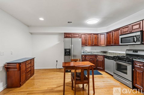 A kitchen with wooden cabinets and a table set for two.