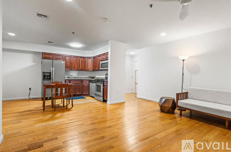 A kitchen with wooden floors and a dining table.