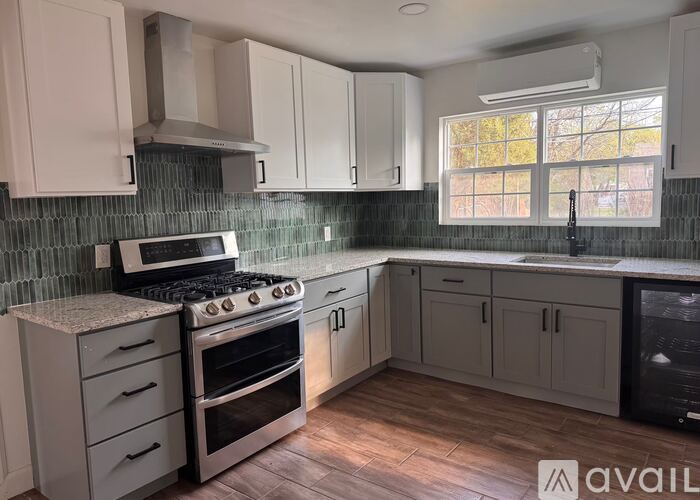 A kitchen with a stove, oven, and cabinets.