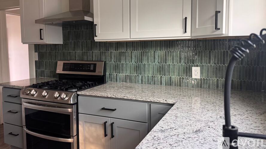 A kitchen with a stove, oven, and cabinets.