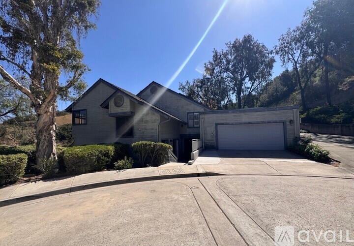 A house with a driveway and garage is available for sale.
