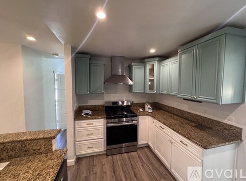 A kitchen with a stove top oven and a counter top.