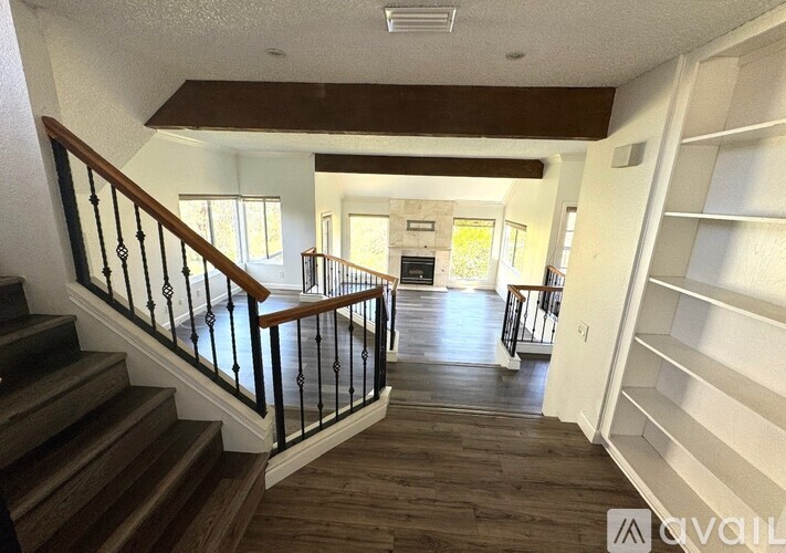 A spacious interior of a house with a staircase leading to the upper floor.