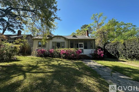 A house with a front yard and a driveway.