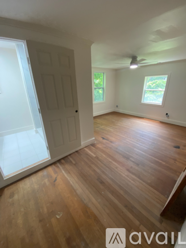 A room with wooden floors and a window.