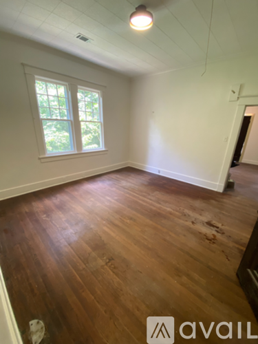 A room with wooden floors and a window.