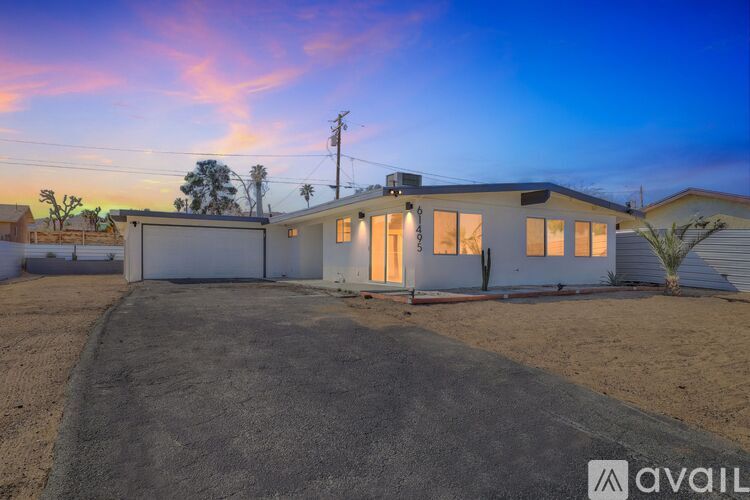 A house with a driveway in front of it is available for sale.