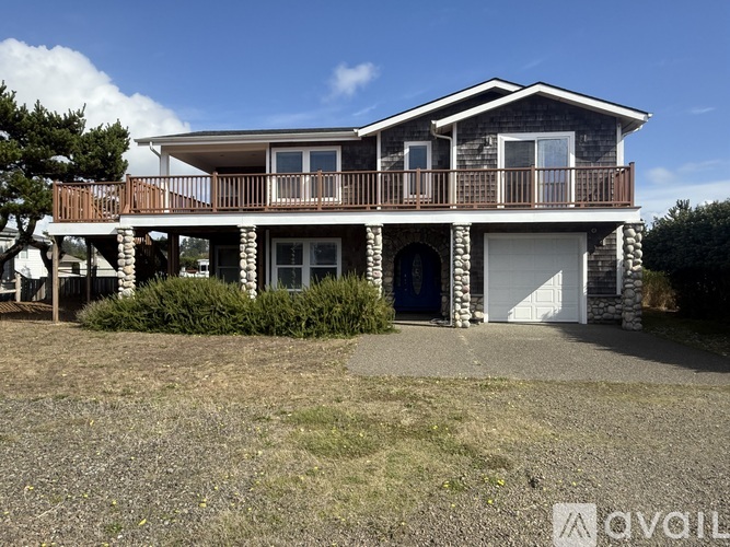 A two-story house with a balcony and a garage.