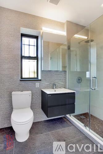 A bathroom with a toilet, sink, and mirror.